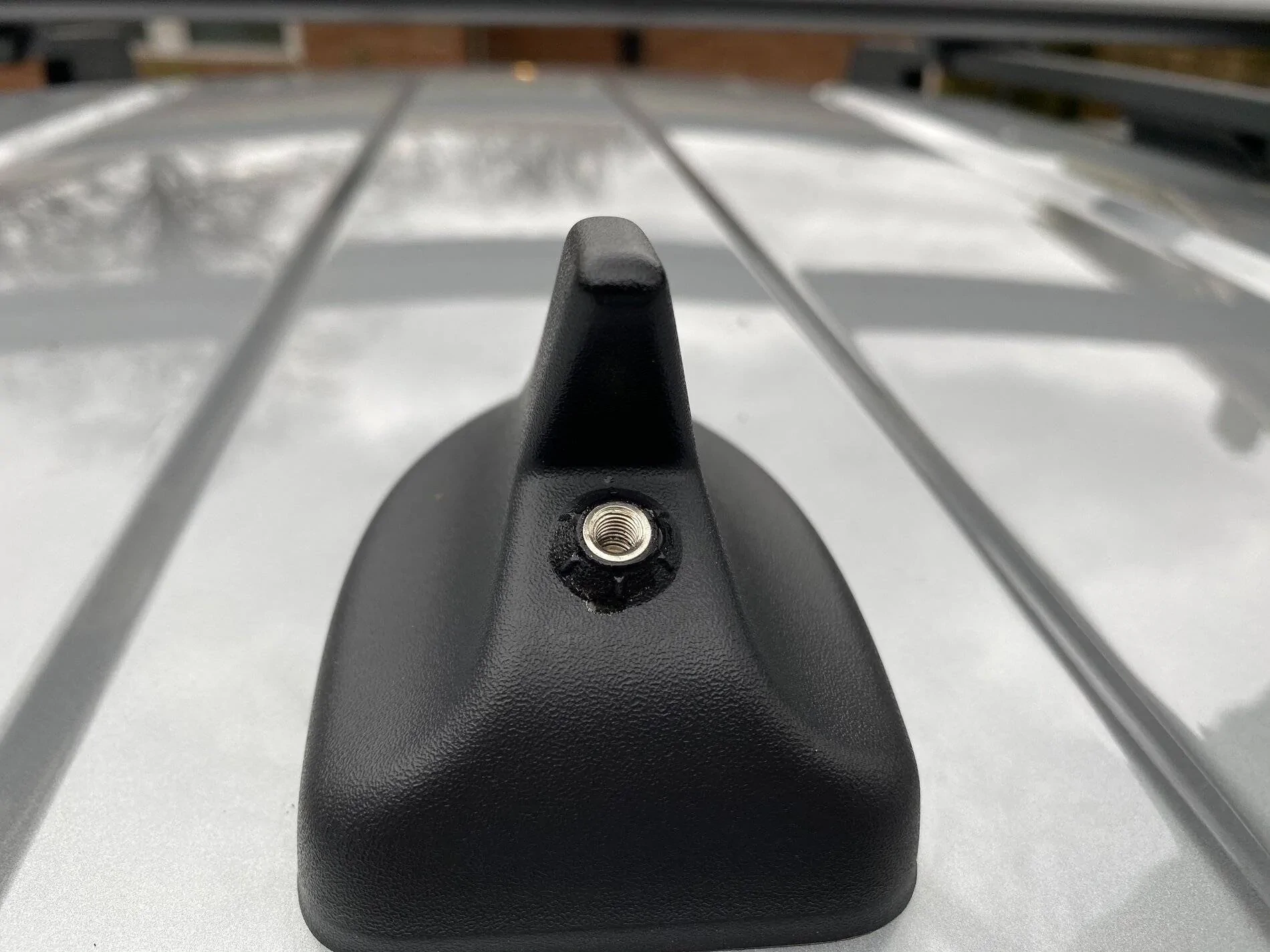 Factory crossbars allow for a surfboard to clear that antenna in the